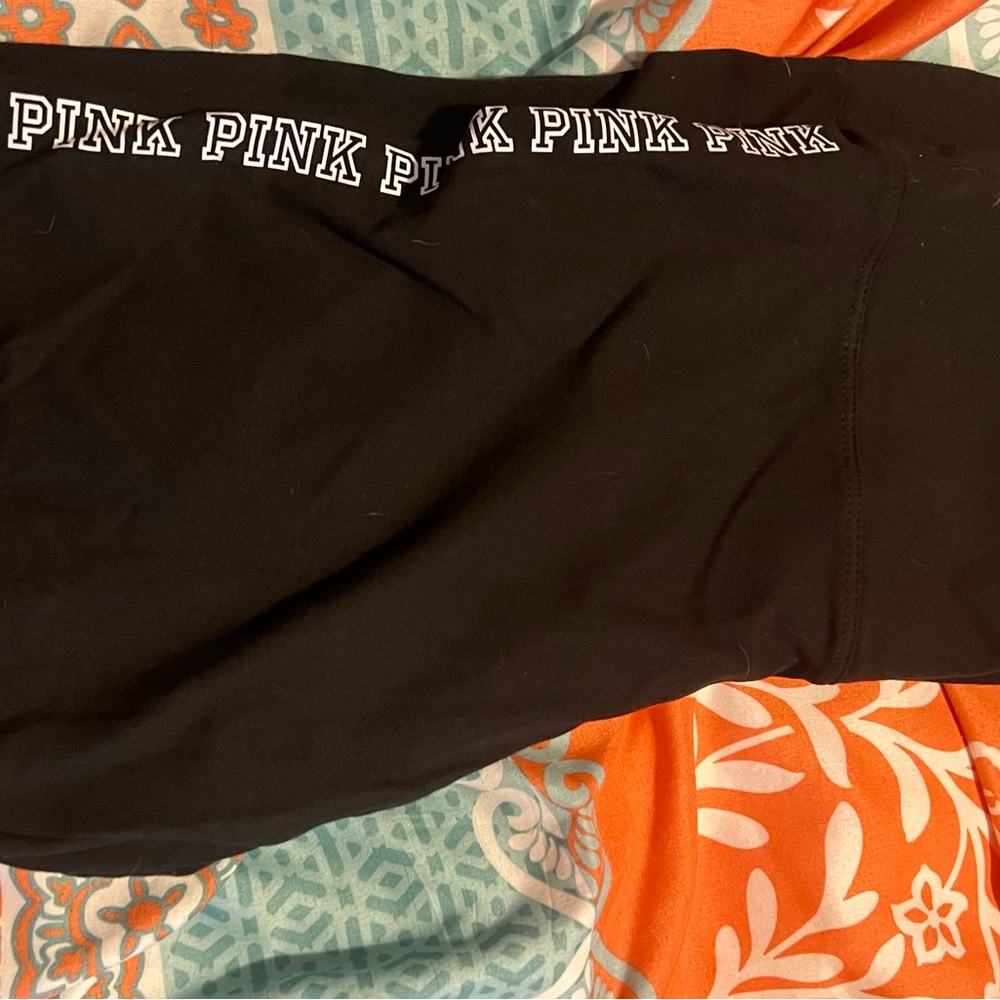 Pink stretch pants black with white writing on side